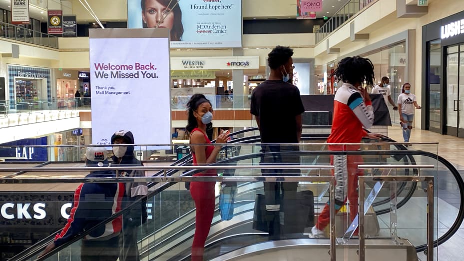 Customers ride an escalator at The Galleria shopping mall after it opened during the coronavirus disease (COVID-19) outbreak in Houston Texas, May 1, 2020.