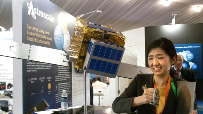 Kanae Kobori, an engineer with Japanese space start-up company Astroscale, demonstrates pulling a magnet off of a piece of steel during the 35th Space Symposium at The Broadmoor in Colorado Springs, Colorado on April 9, 2019.