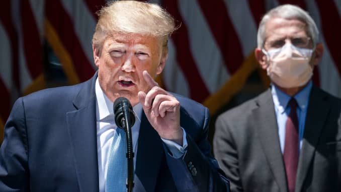 Dr. Anthony Fauci (R), director of the National Institute of Allergy and Infectious Diseases, looks on as U.S. President Donald Trump delivers remarks about coronavirus vaccine development in the Rose Garden of the White House on May 15, 2020 in Washingto