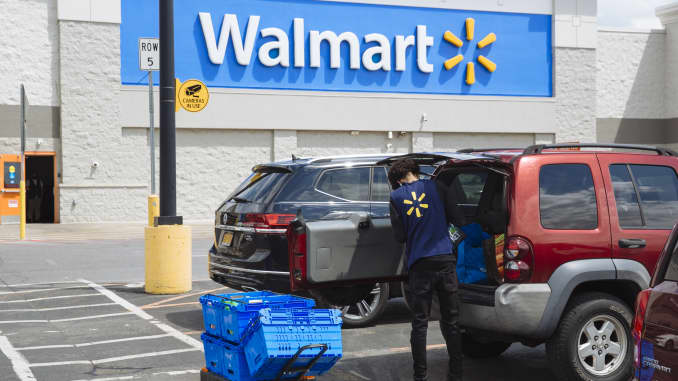 A worker delivers groceries to a customer's vehicle outside a Walmart Inc. store in Amsterdam, New York, on Friday, May 15, 2020.