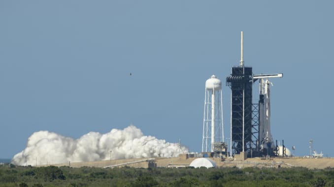 The SpaceX Falcon 9 rocket that will carry the company's Crew Dragon spacecraft for Demo-2 fires up its engines during a test.