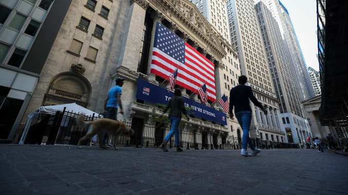 People are walking by the New York Stock Exchange (NYSE) building during Covid-19 pandemic in Lower Manhattan, New York City, United States on May 26, 2020.