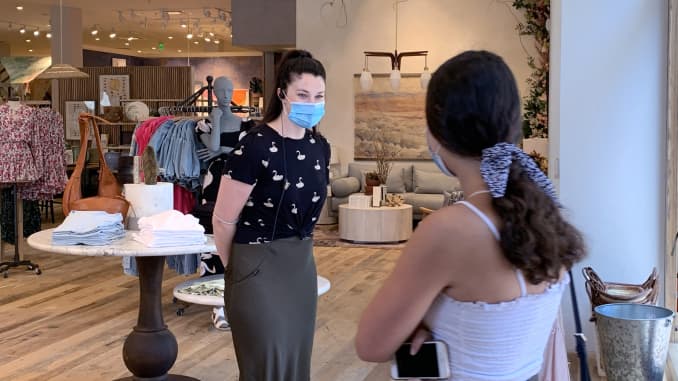 An employee at Anthropologie at Fashion Island greets customers at the store in Newport Beach, CA on Tuesday, May 26, 2020.