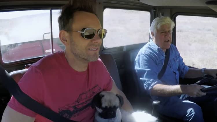 Jay Leno takes Joel McHale and his dogs for a ride in a 1996 Mercedes Unimog