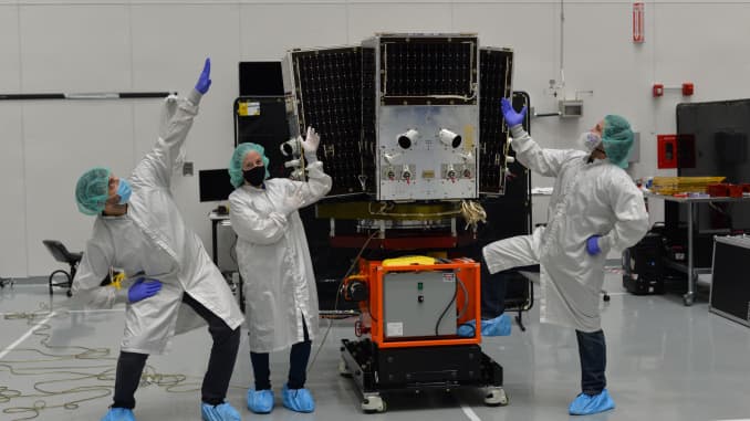 Planet engineers in a cleanroom with a SkySat satellite.