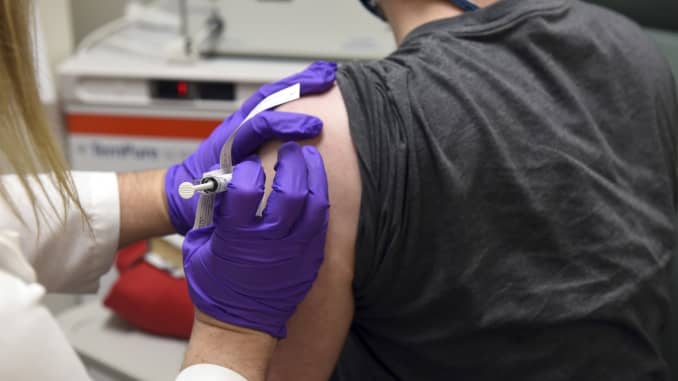 In this May 4, 2020 photo provided by the University of Maryland School of Medicine, the first patient enrolled in Pfizer's COVID-19 coronavirus vaccine clinical trial at the University of Maryland School of Medicine in Baltimore, receives an injection.