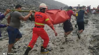 People carry a dead body following a landslide at a mining site in Hpakant, Kachin State City, Myanmar July 2, 2020, in this picture obtained from social media.