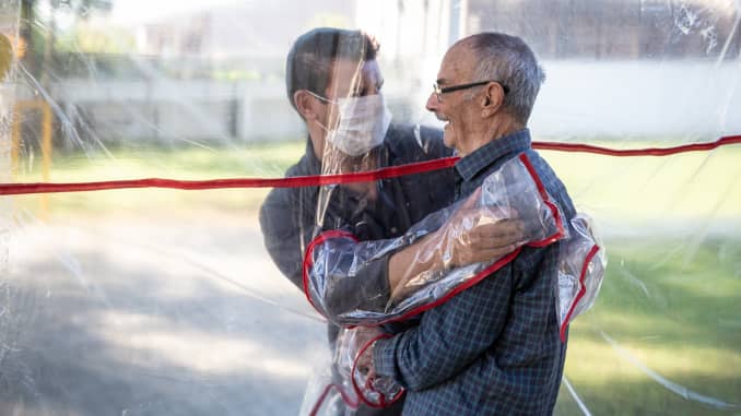 A son hugs his father at the Geriatric Clinic Três Figueiras on June 16, 2020 in Gravatai, Brazil. The clinic created the Tunel do Abraco (hug tunnel) for elderly residents to be able to hug relatives after more than 70 days apart due to the coronavirus pandemic. The tunnel is made of a thick plastic curtain with sleeves, which guarantees the safety of families. After each use, the environment is cleaned by a clinic professional.