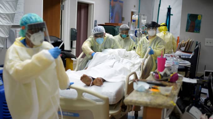 Healthcare workers move a patient in the Covid-19 Unit at United Memorial Medical Center in Houston, Texas Thursday, July 2, 2020.