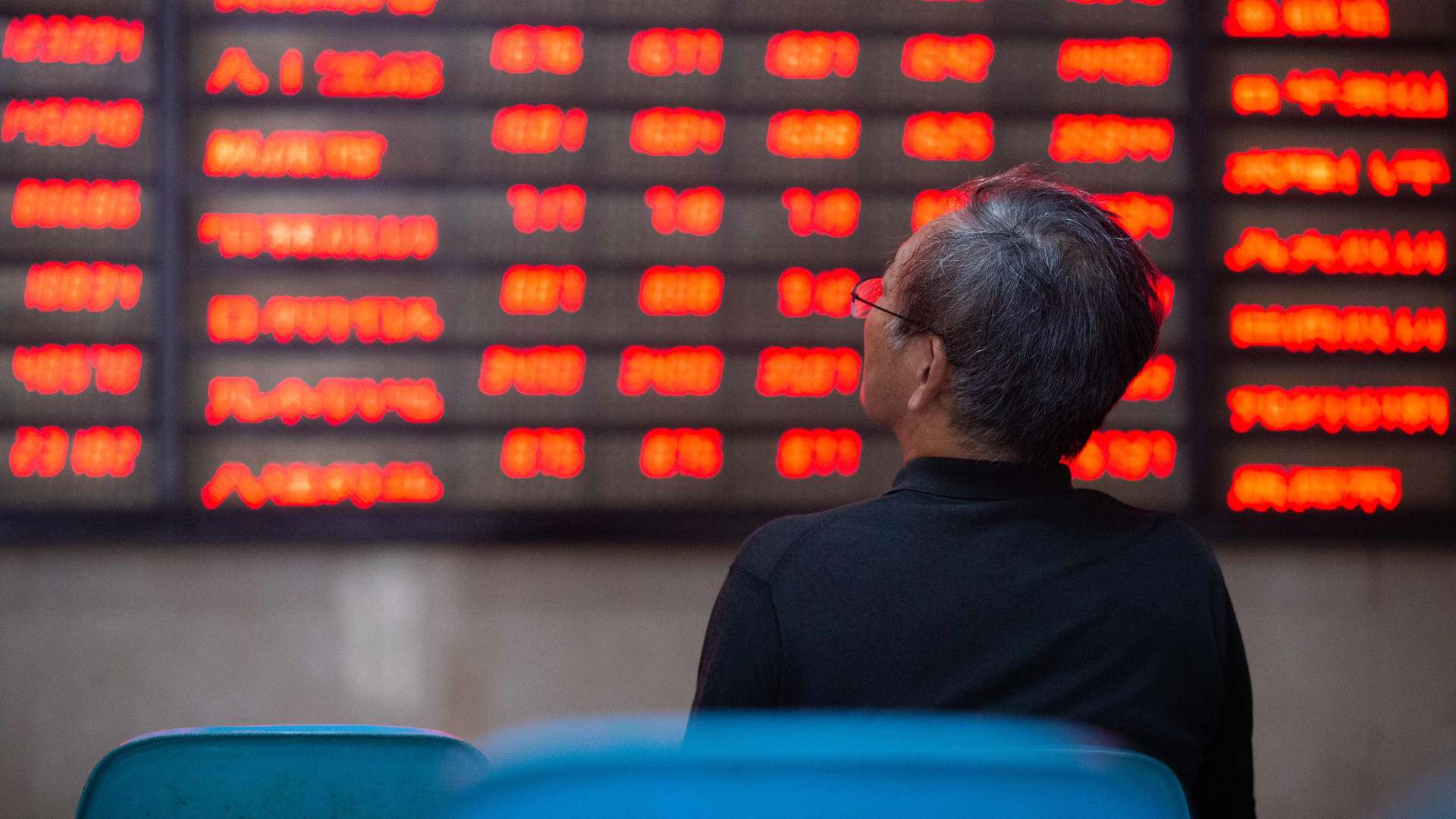 A shareholder watches the stock market in a securities business hall. Nanjing, Jiangsu Province, China, 6 July 2020.