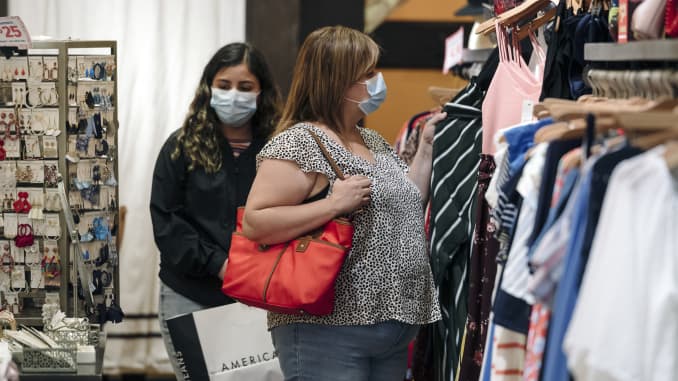 Shoppers wearing protective masks browse clothing at a store at Westfield San Francisco Centre in San Francisco, California, U.S., on Thursday, June 18, 2020.
