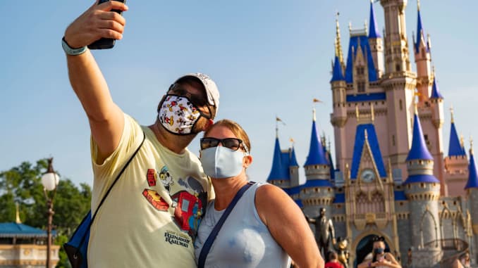 En esta fotografía proporcionada por Walt Disney World Resort, los visitantes se detienen para tomarse una selfie en Magic Kingdom Park en Walt Disney World Resort el 11 de julio de 2020 en Lake Buena Vista, Florida.  El 11 de julio de 2020 es el primer día de la reapertura gradual.