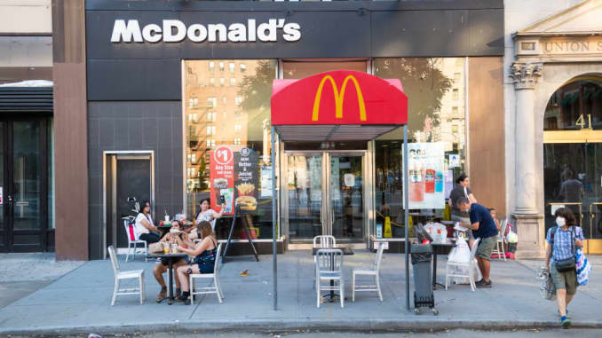 People dine outside McDonald's in Union Square as New York City moves into Phase 3 of re-opening following restrictions imposed to curb the coronavirus pandemic on July 12, 2020.