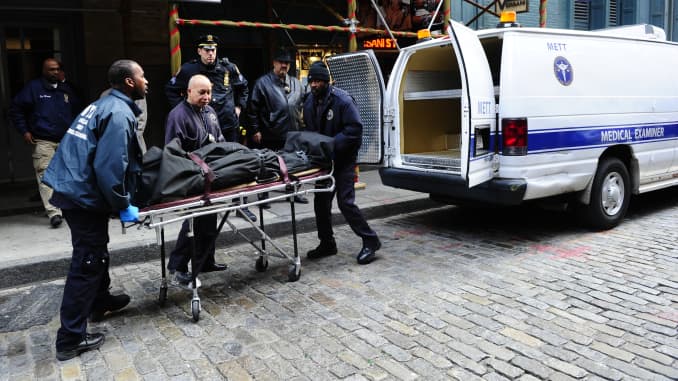 Medical examiners remove the body of Mark Madoff, the son of disgraced financier Bernard Madoff, after he hanged himself in his New York apartment on December 11, 2010, the second anniversary of his father's arrest for perpetrating Wall Street's biggest e