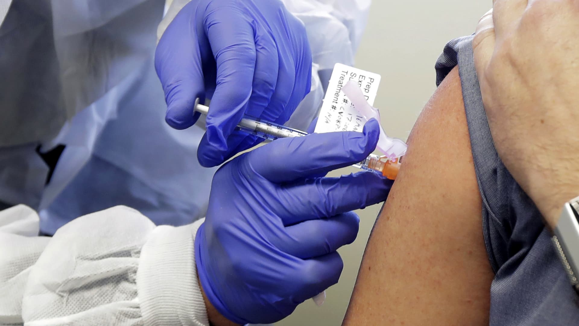 In this March 16, 2020, file photo, a subject receives a shot in the first-stage safety study clinical trial of a potential vaccine by Moderna for COVID-19, the disease caused by the new coronavirus, at the Kaiser Permanente Washington Health Research Institute in Seattle.