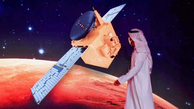 An Emirati walks past a screen displaying the "Hope" Mars probe at the Mohammed Bin Rashid Space Centre in Dubai on July 19, 2020, ahead of it's expected launch from Japan. The probe is one of three racing to the Red Planet.