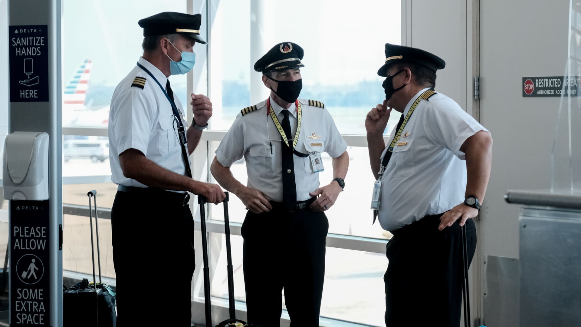 Pilots talk after exiting a Delta Airlines flight at the Ronald Reagan National Airport on July 22, 2020 in Arlington, Virginia.