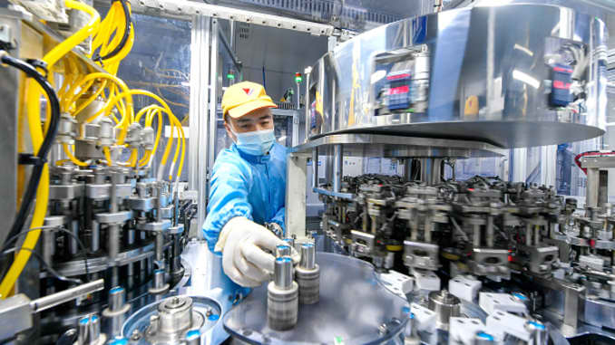 An employee works on the production line of lithium battery at a factory of Tianneng Battery Group Co., Ltd on July 20, 2020 in Changxing County, Zhejiang Province of China.