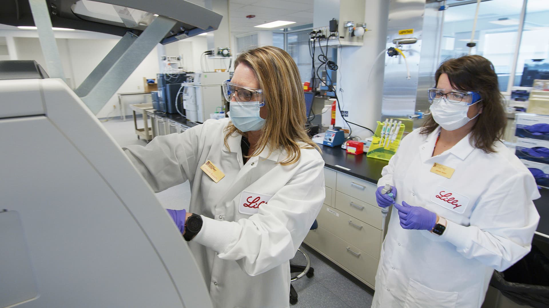 In this May 2020 photo provided by Eli Lilly, researchers prepare mammalian cells to produce possible COVID-19 antibodies for testing in a laboratory in Indianapolis.