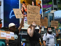 Protesters rally demanding economic relief during the coronavirus pandemic, at Time Square on August 5, 2020 in New York City.