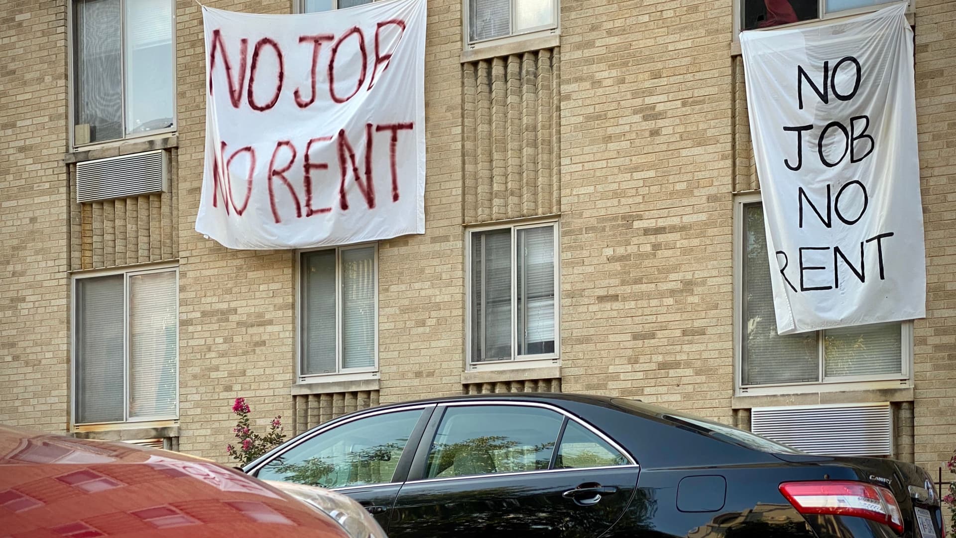Anti-eviction banners are displayed on a rent-controlled building in Washington, D.C., on Aug. 9, 2020.