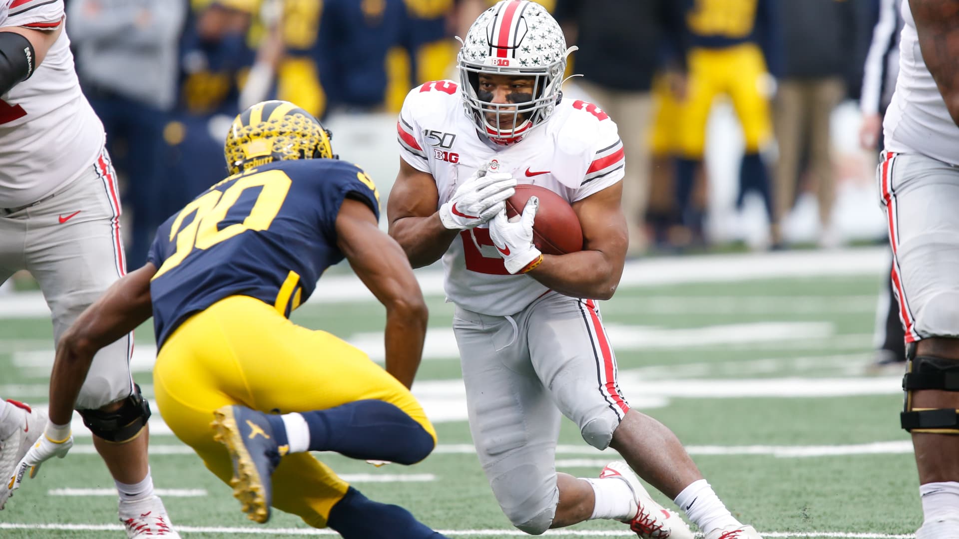 Ohio State Buckeyes running back J.K. Dobbins (2) runs with the ball while trying to avoid being tackled by Michigan Wolverines defensive back Daxton Hill (30) during a regular season Big 10 Conference game between the Ohio State Buckeyes (2) and the Michigan Wolverines.