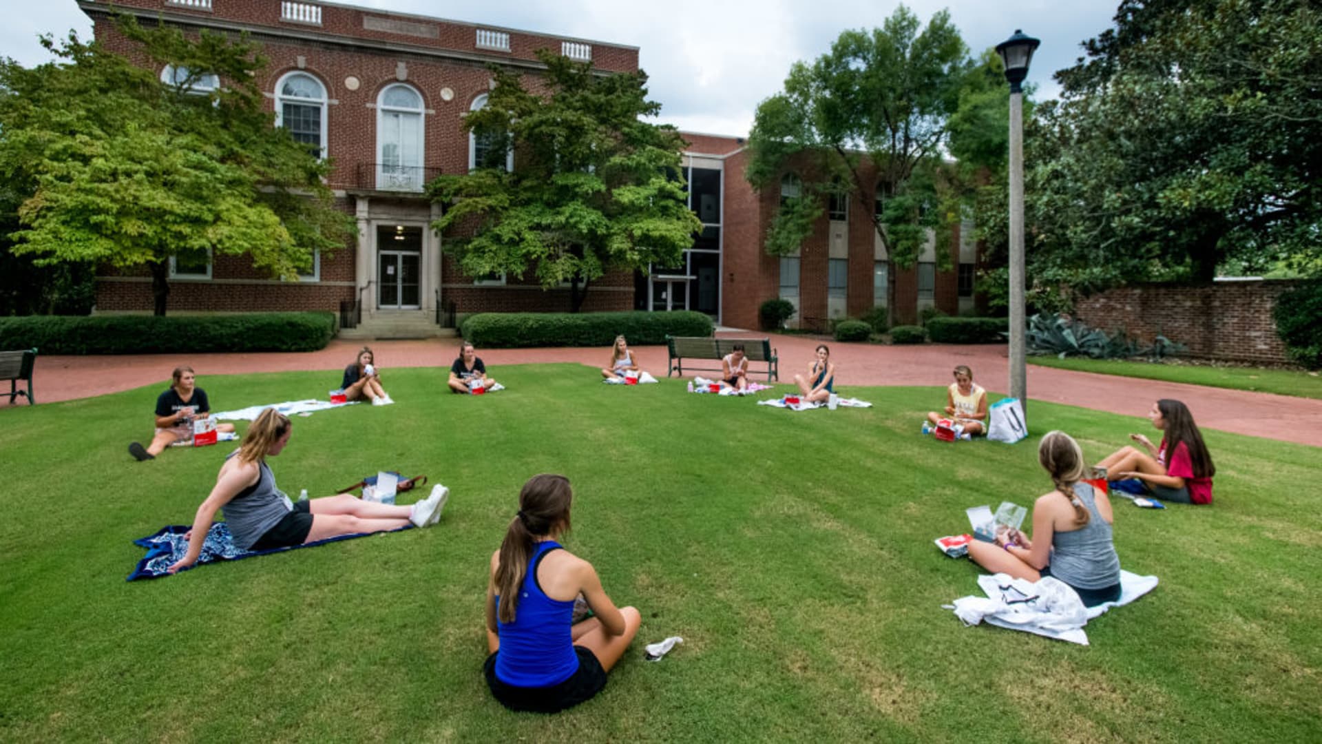 College students eat dinner outside at the University of South Carolina on August 10, 2020 in Columbia, South Carolina. Students began moving back to campus housing August 9 with classes to start August 20.