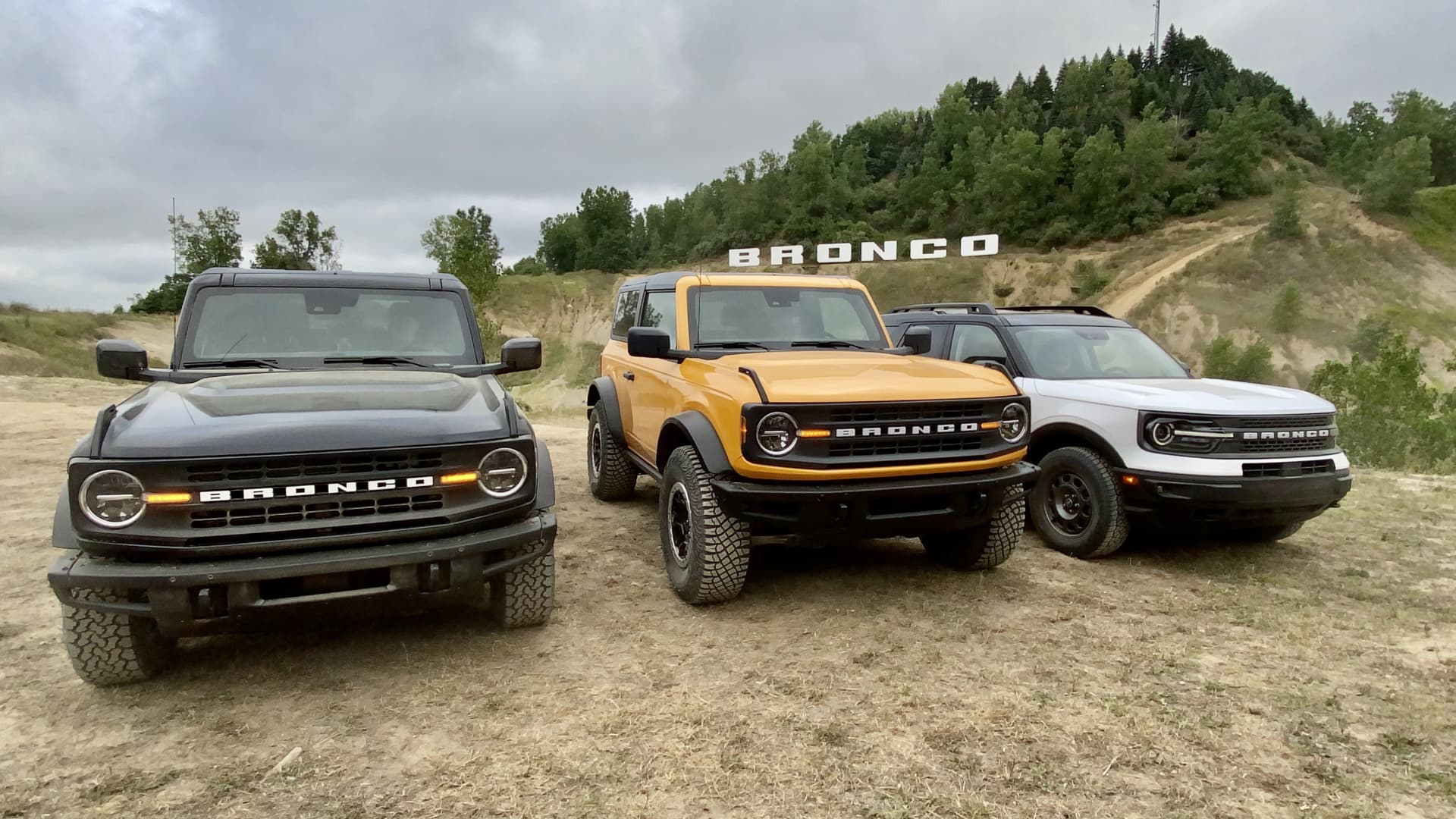 Ford's new 2021 Bronco lineup -- four- and two-door Bronco models and the Bronco Sport (left to right) -- displayed at an off-road course on Aug. 11, 2020 in Michigan.