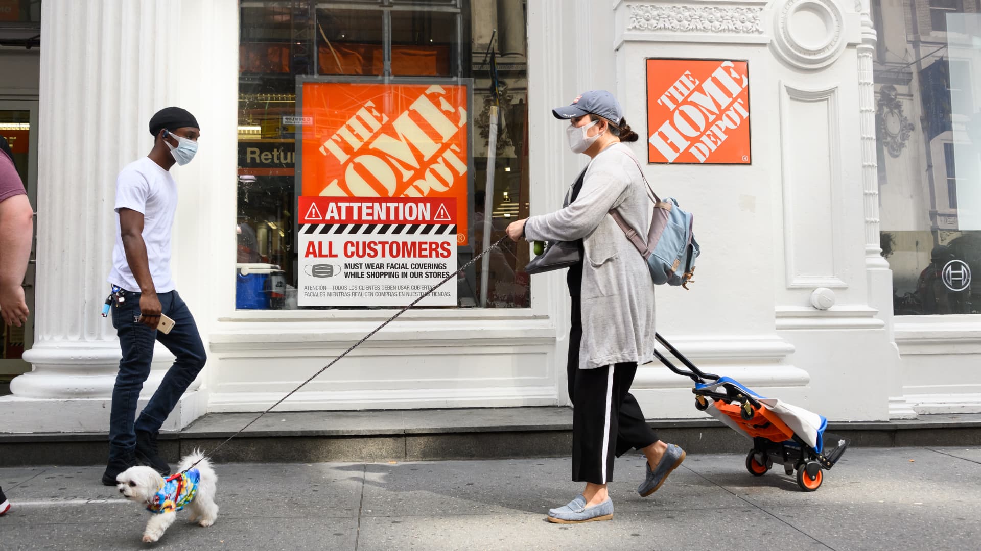 People wear protective face masks outside Home Depot in the Flatiron district as the city continues Phase 4 of re-opening following restrictions imposed to slow the spread of coronavirus on August 8, 2020 in New York City.