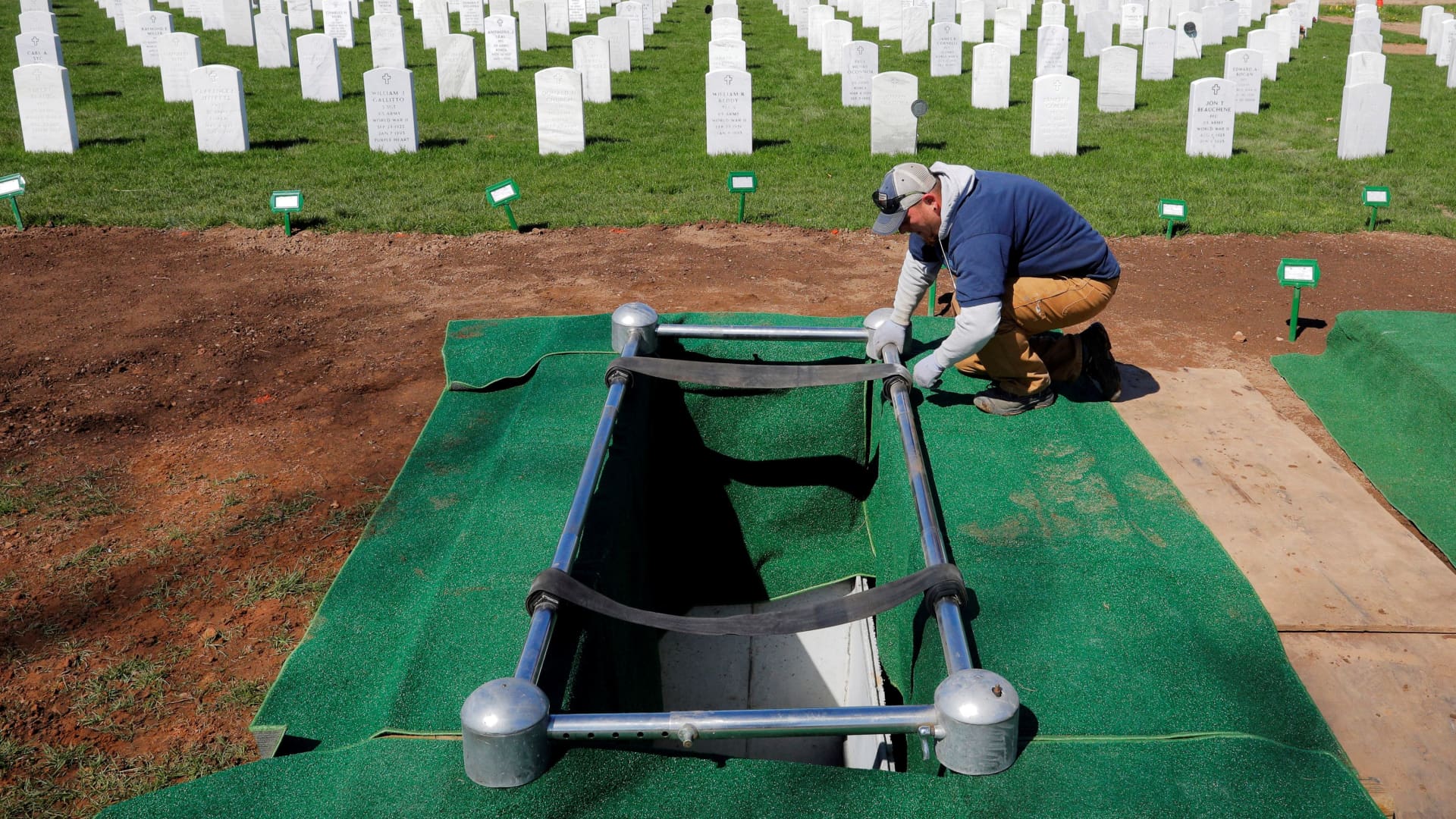 Cemetery worker Keith Yatcko prepares a grave for a burial at the State Veterans Cemetery amid the coronavirus disease (COVID-19) outbreak in Middletown, Connecticut, U.S., May 13, 2020.