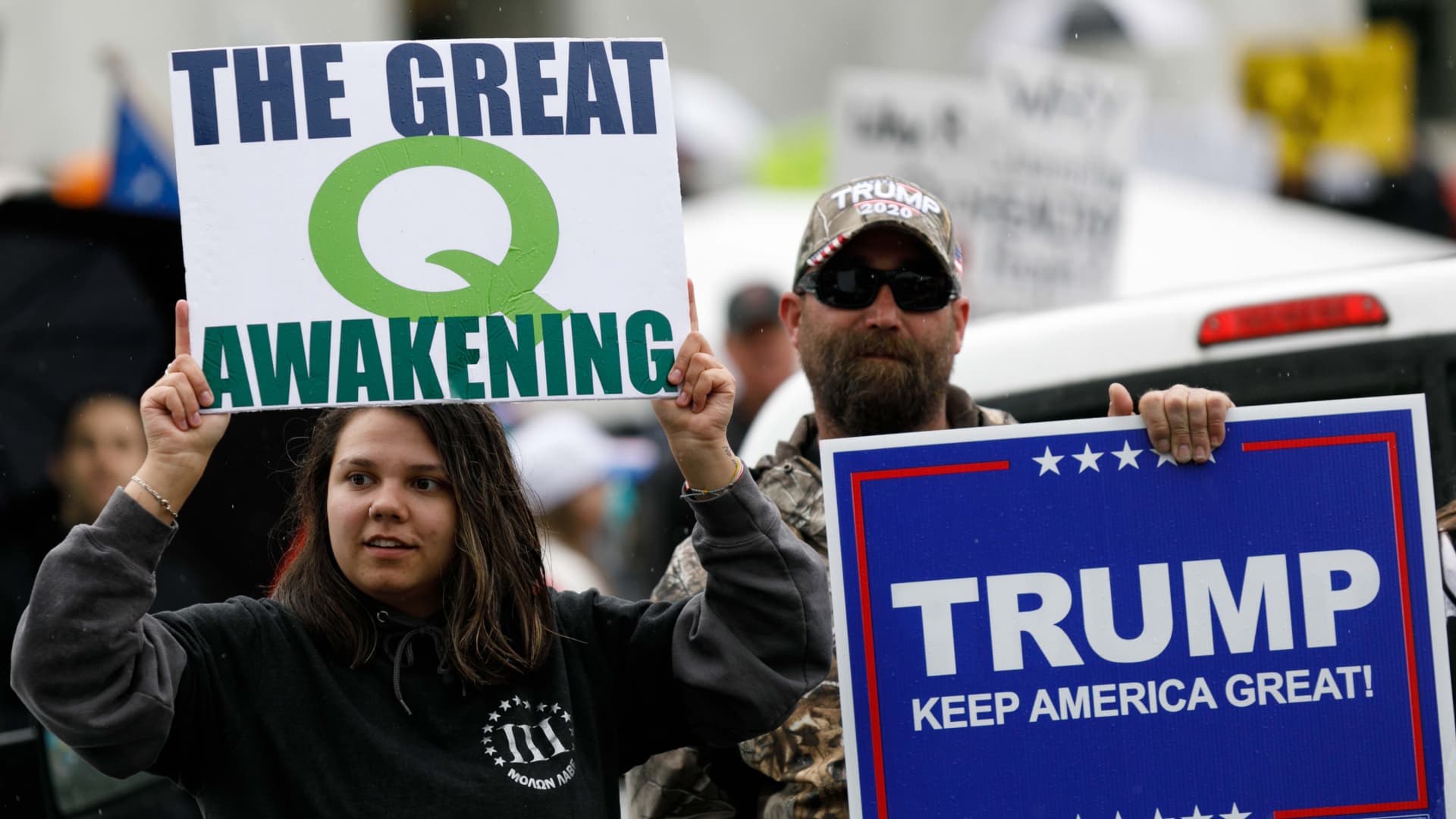 The Q-Anon conspiracy theorists hold signs during the protest at the State Capitol in Salem, Oregon, United States on May 2, 2020.