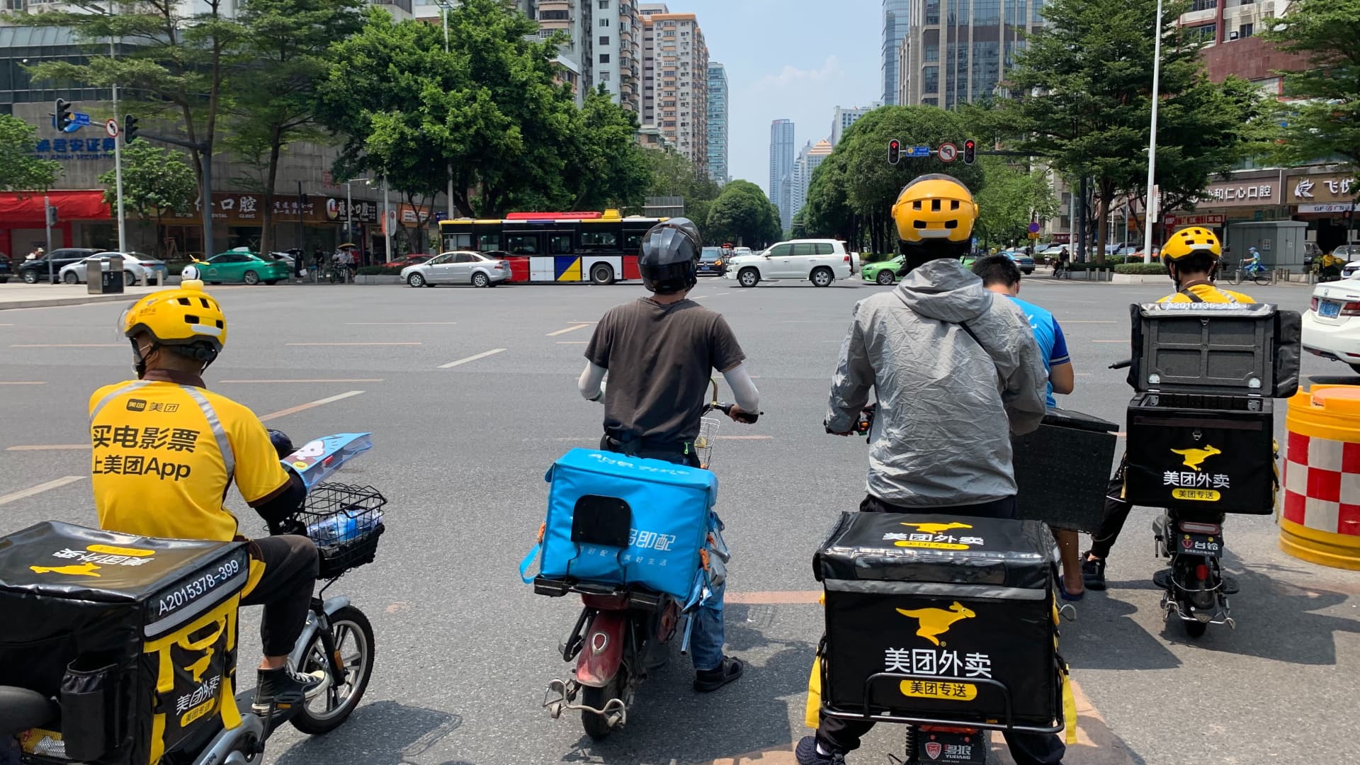 Drivers for Meituan and Alibaba-owned Ele.me en route to delivering items to customers in Guangzhou, China.