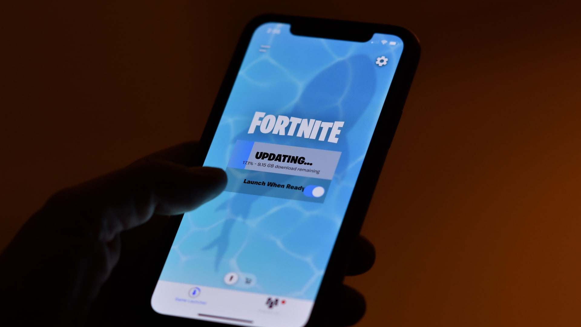 This illustration picture shows a person waiting for an update of Epic Games' Fortnite on their smartphone in Los Angeles on August 14, 2020.