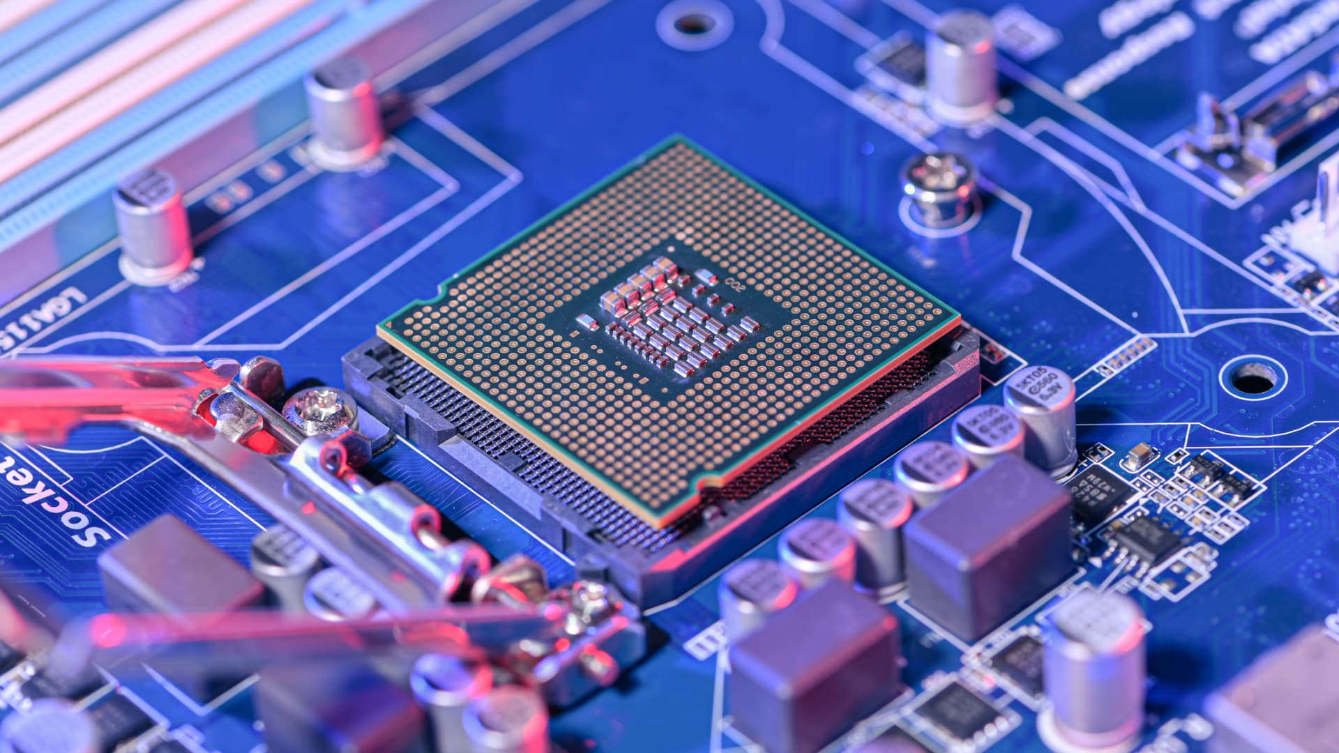 A close up image of a CPU socket and motherboard laying on the table.
