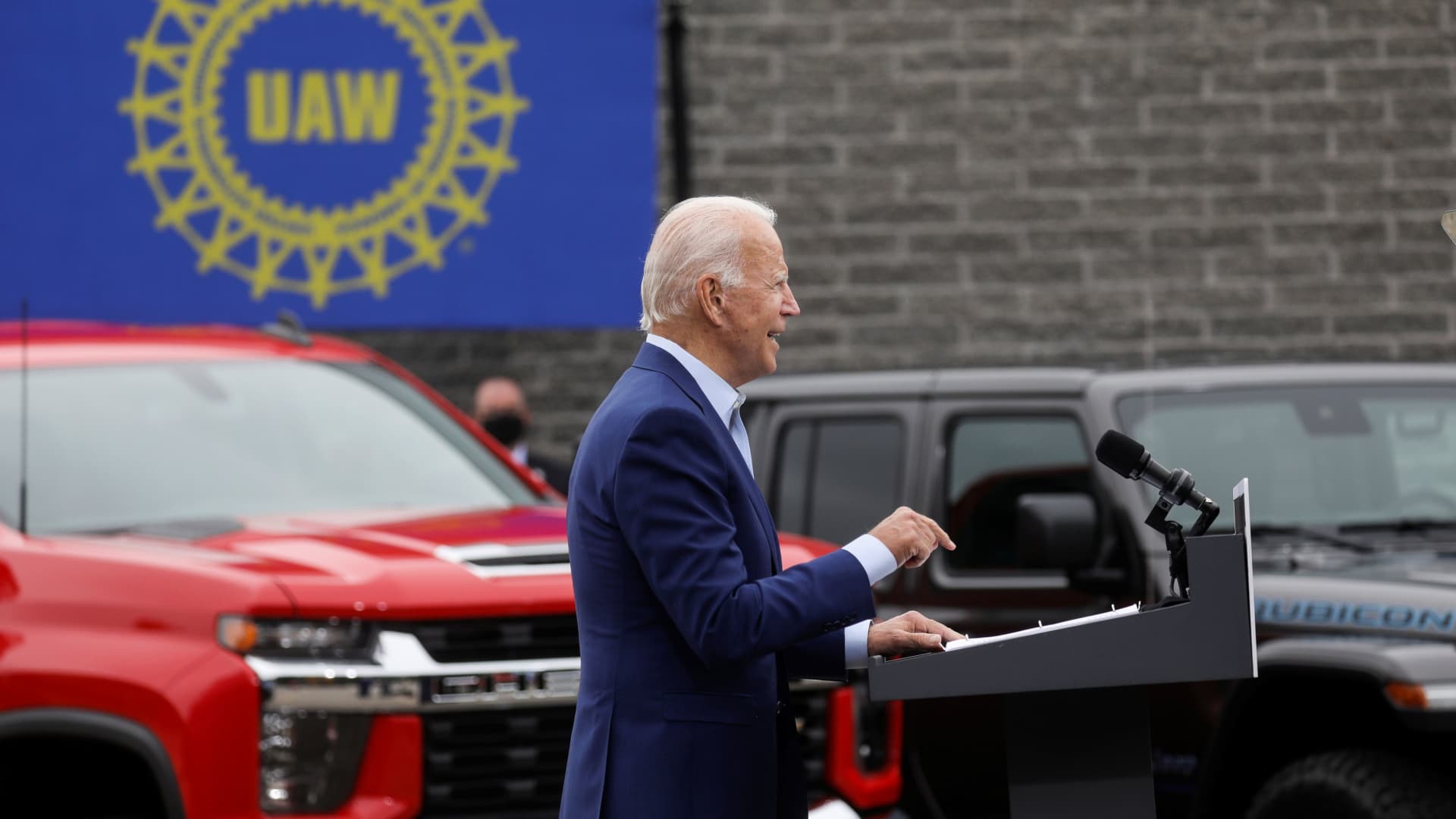 Speaking in front of a backdrop of American-made vehicles and a UAW sign, President Joe Biden speaks about new proposals to protect U.S. jobs during a campaign stop in Warren, Michigan, September 9, 2020.