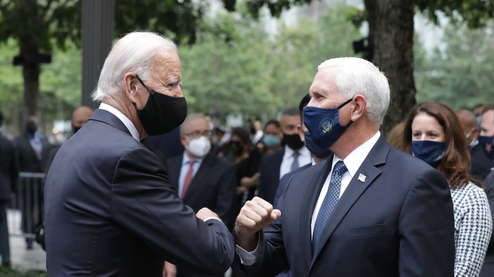 Democratic presidential nominee Joe Biden (L) and U.S. Vice President Mike Pence (R) greet each other during a 9/11 memorial service at the National September 11 Memorial and Museum on September 11, 2020 in New York City.
