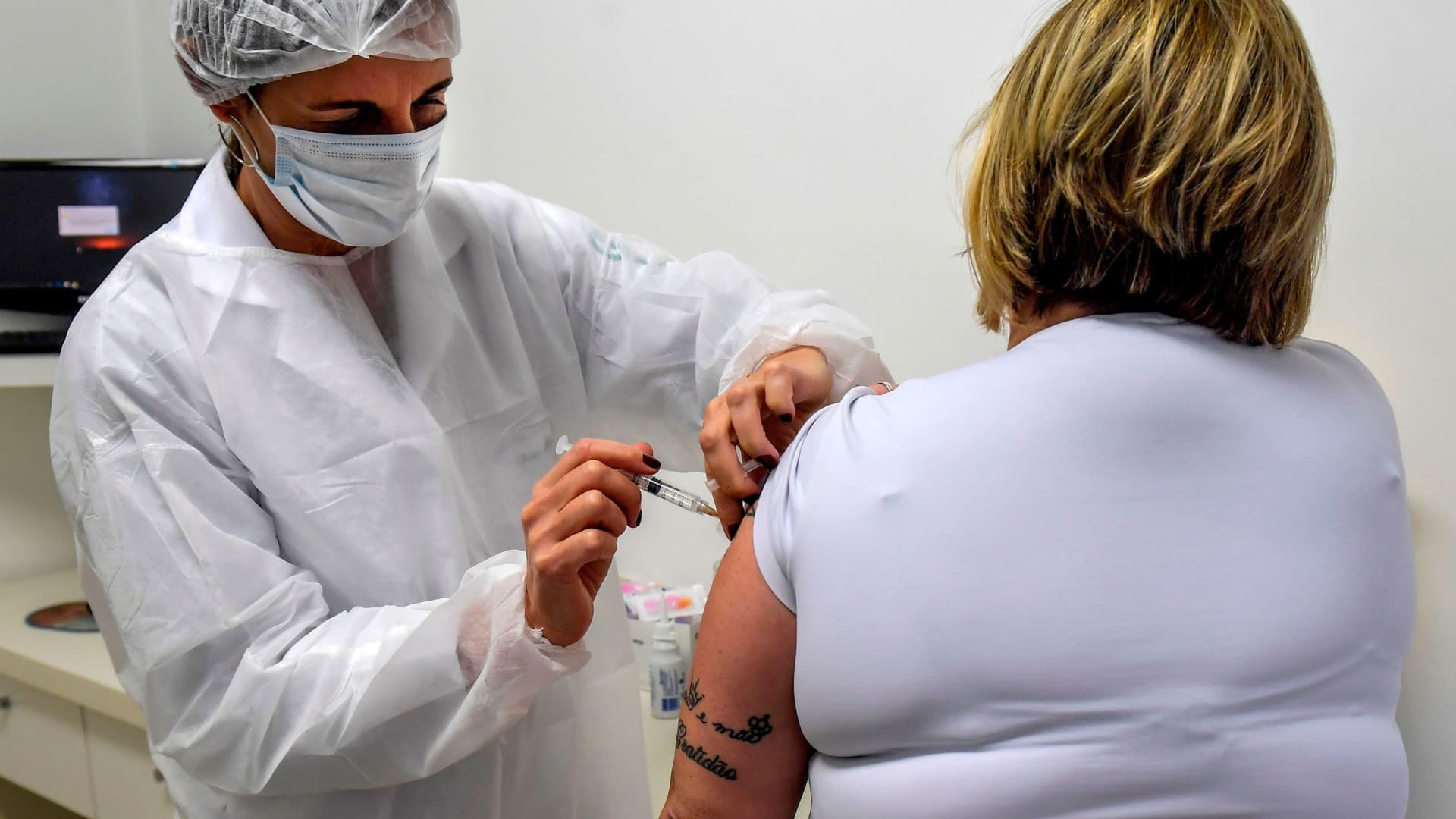 A Brazilian doctor voluntarily receives an injection as part of phase 3 trials of a vaccine developed by the University of Oxford and British pharmaceutical company AstraZeneca, in July 2020.