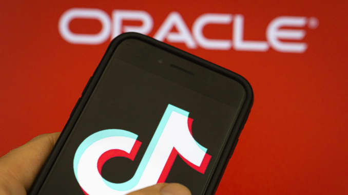 The logos of the Chinese video portal TikTok and the US software and hardware manufacturer Oracle Corporation can be seen on a smartphone and screen on September 14, 2020 in Berlin, Germany.