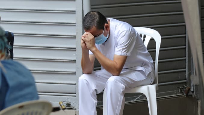 A doctor treating patients with symptoms related to coronavirus takes a break at a health clinic on April 3, 2020 in Guayaquil, Ecuador.