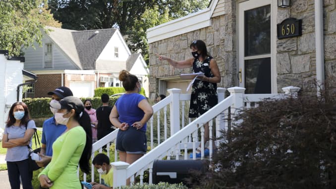 Robin Azougi 1st R, a licensed real estate salesperson with Douglas Elliman Real Estate, talks with prospective buyers at a house for sale in Floral Park, Nassau County, New York, the United States, on Sept. 6, 2020.