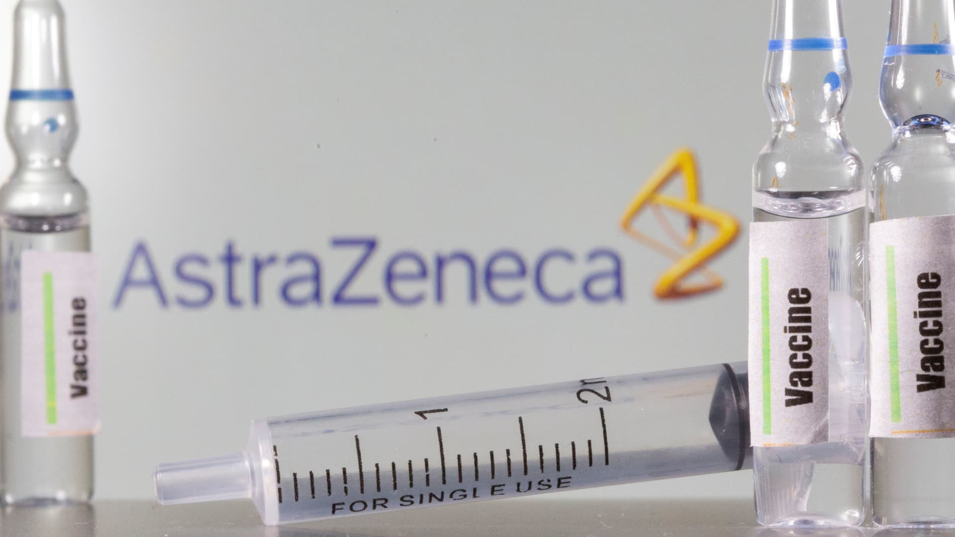 A test tube labelled vaccine is seen in front of AstraZeneca logo in this illustration taken, September 9, 2020.