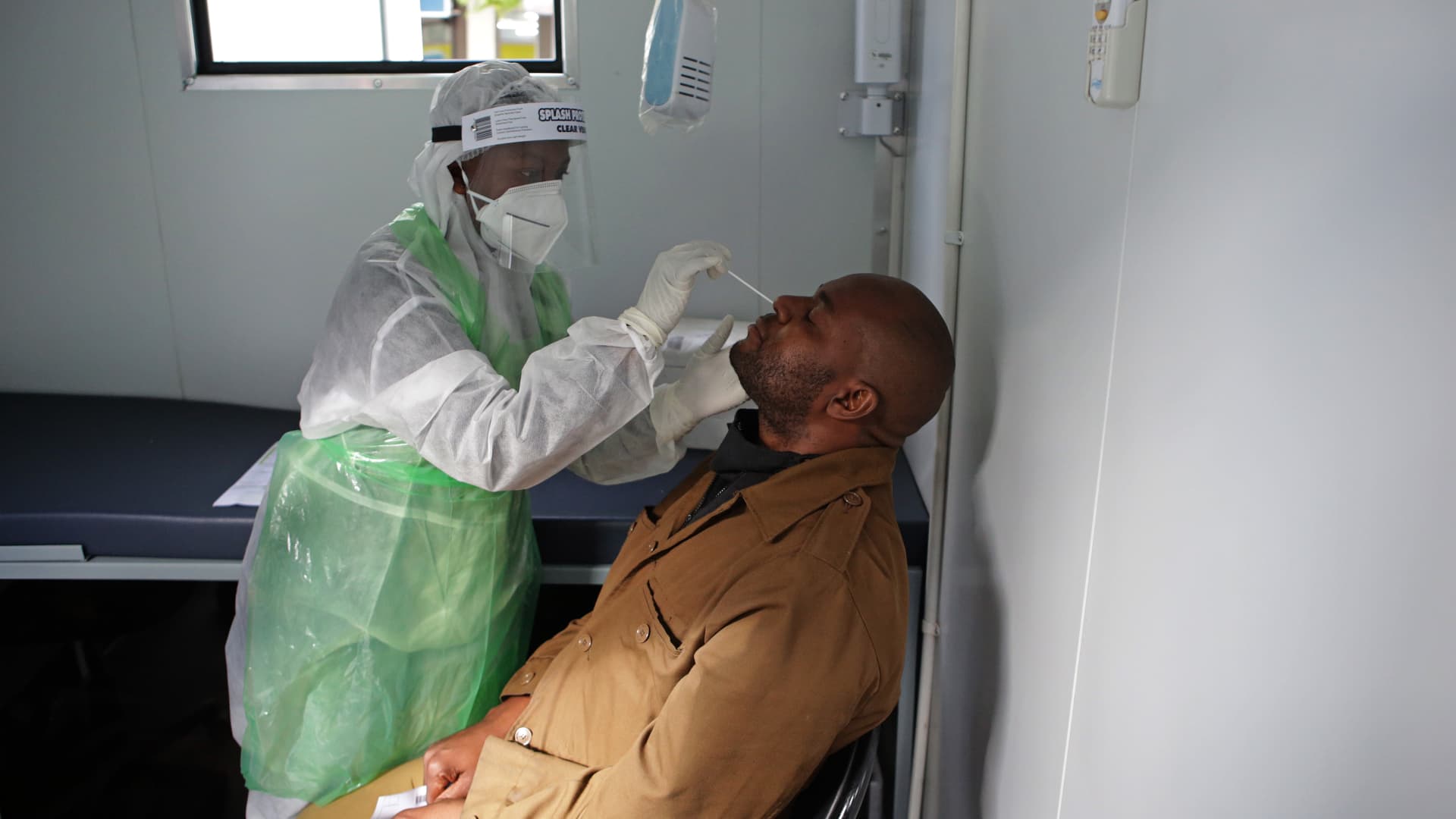 A City of Tshwane Health official takes a nasal swab to test for the COVID-19 coronavirus on a taxi operator at the Bloed Street Mall in Pretoria Central Business District, on June 11, 2020.