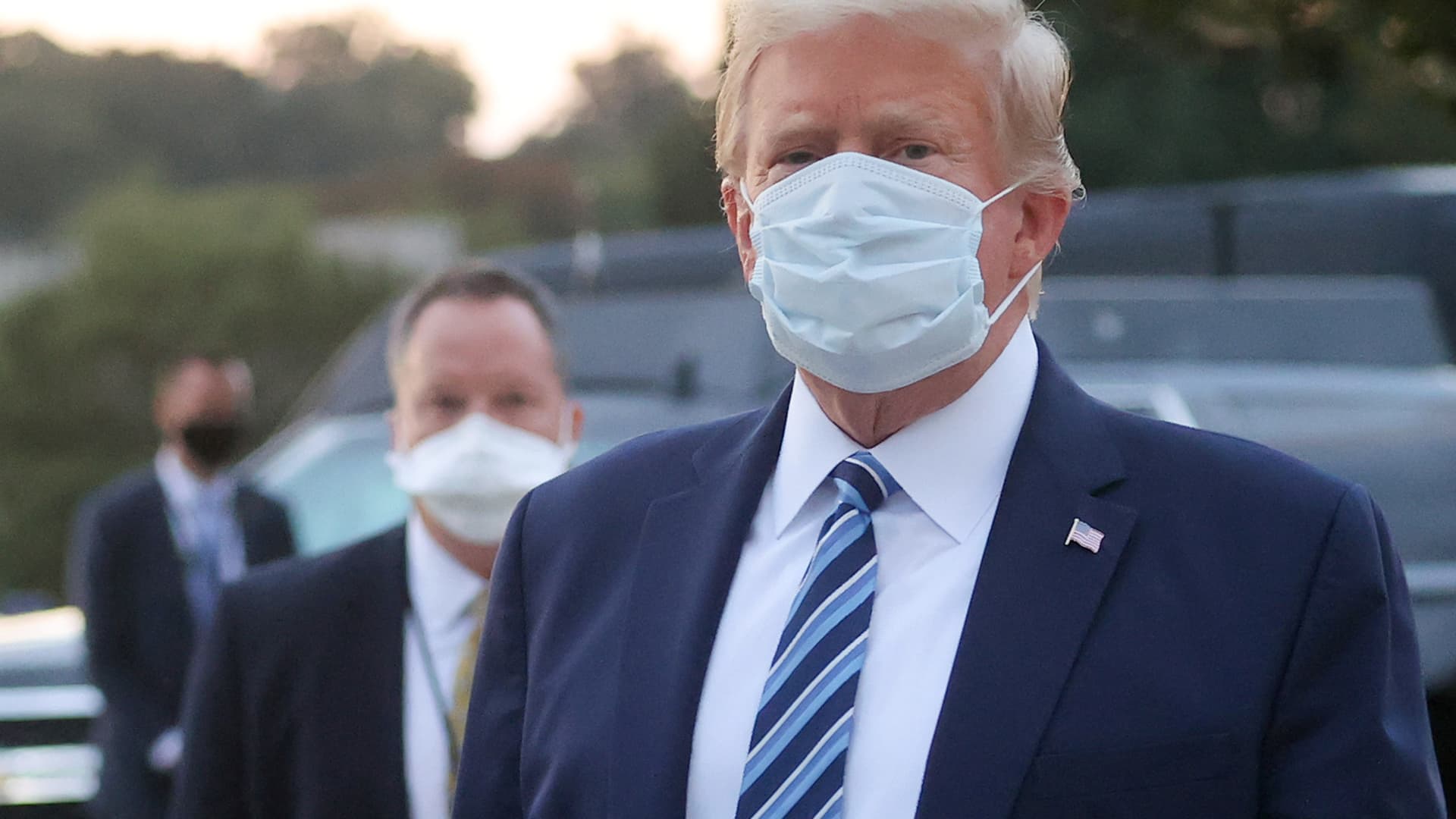 U.S. President Donald Trump looks over at reporters and photographers as the president departs Walter Reed National Military Medical Center after a fourth day of treatment for the coronavirus disease (COVID-19) to return to the White House in Washington from the hospital in Bethesda, Maryland, U.S., October 5, 2020.