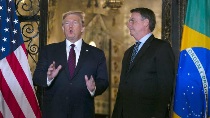U.S. President Donald Trump, left, speaks as Jair Bolsonaro, Brazil's president, stands at Mar-a-Lago resort in Palm Beach, Florida, U.S., on Saturday, March 7, 2020. Bolsonaro, a Trump admirer who fashioned his successful election campaign after the American president's, traveled to Florida to meet with business leaders and Trump himself.