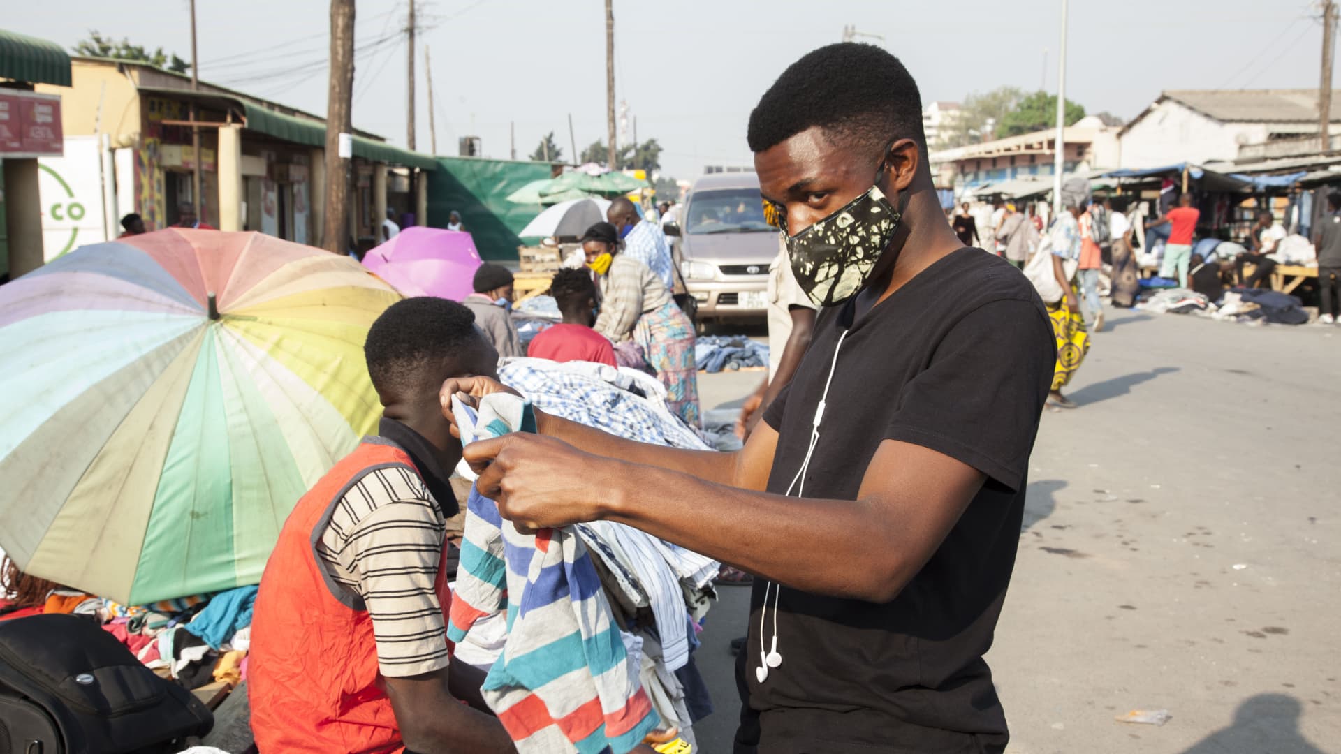 A man wearing a face mask selects clothes at a market in Lusaka, capital of Zambia, on Aug. 18, 2020. Zambia's confirmed COVID-19 cases have continued rising, with the total number close to the 10,000 mark.