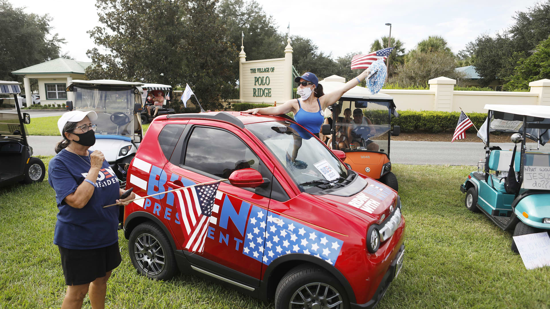 Paula Orlando, a supporters of Democratic Presidential nominee Joe Biden, waves her flag next to her car during President Donald Trump's campaign stop at The Villages Polo Club on October 23, 2020 in The Villages, Florida.