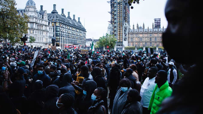 Activists protesting police brutality by the Nigerian Special Anti-Robbery Squad (SARS) demonstrate in Parliament Square in London, England, on October 21, 2020. SARS has been accused of extrajudicial killings, extortion and torture, prompting demonstrations across Nigeria that have seen at least 56 people killed by Nigerian security forces in recent weeks, according to human rights group Amnesty International.