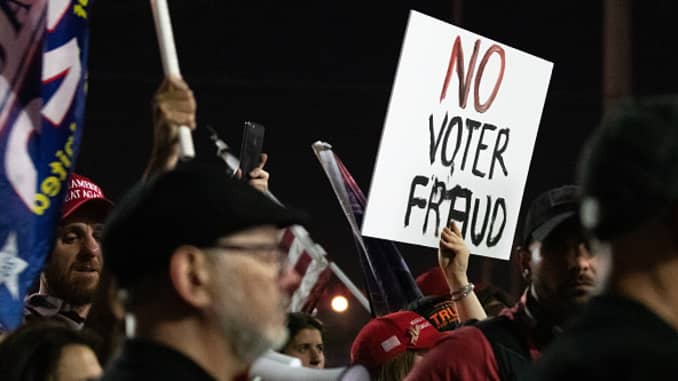 A no voter fraud sign is displayed by a protester in support of President Donald Trump at the Maricopa County Elections Department office on November 4, 2020 in Phoenix, Arizona.