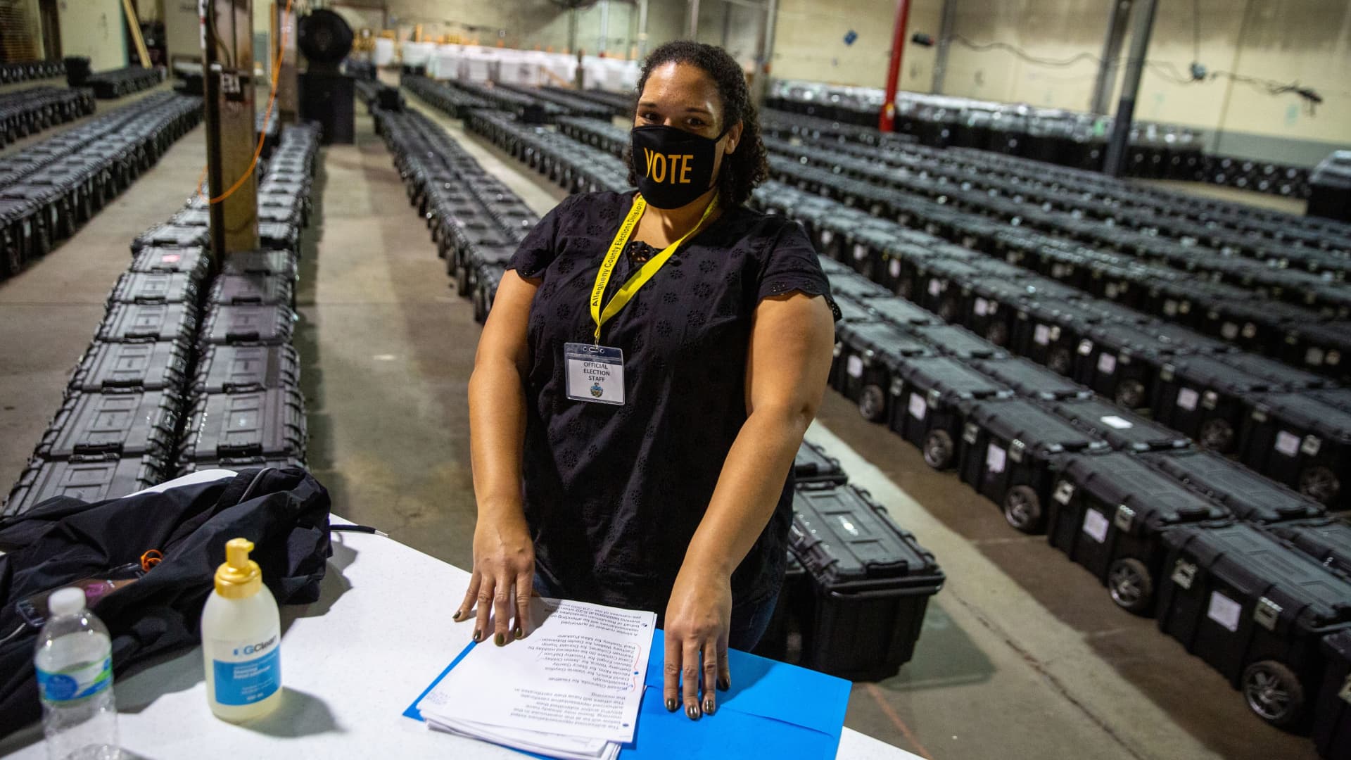 Poll worker Angela Steele mans the check-in desk near rows of empty ballot boxes at the Allegheny County Election Warehouse after the election in Pittsburgh, Pennsylvania, U.S. November 6, 2020.