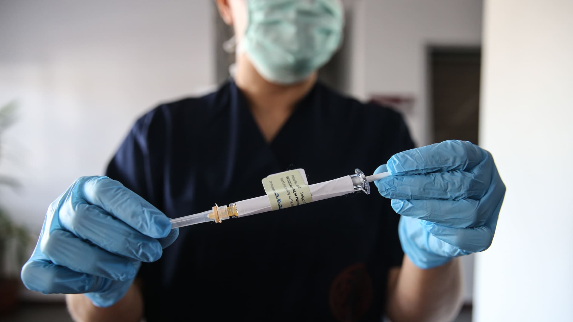 A health care worker holds an injection syringe of the phase 3 vaccine trial, developed against the novel coronavirus (COVID-19) pandemic by the U.S. Pfizer and German BioNTech company, at the Ankara University Ibni Sina Hospital in Ankara, Turkey on October 27, 2020.